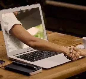 handshake through a laptop